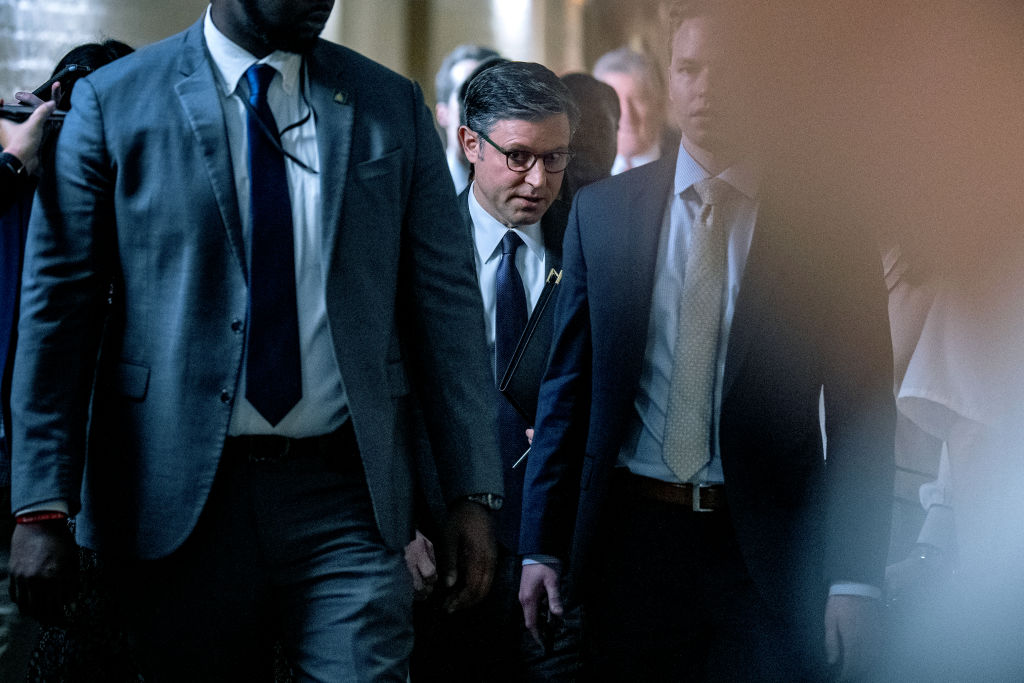 House Speaker Mike Johnson walks to a news conference on Capitol Hill.