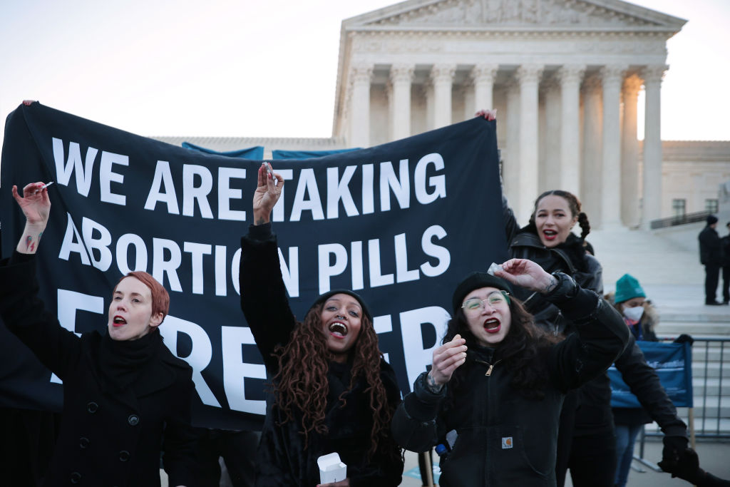 Activists in front of the U.S. Supreme Court during arguments in Dobbs v. Jackson Women's Health in 2021.