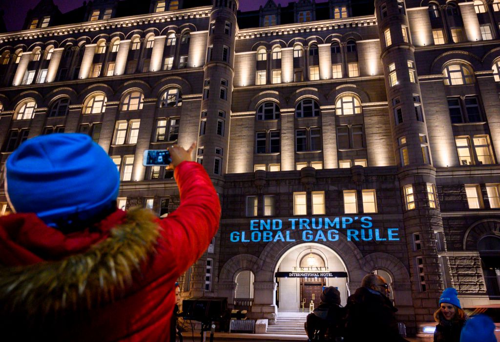 Activists from the Population Connection Action Fund project a message, "End Trump's global gag rule," onto the Trump International Hotel in Washington, D.C.