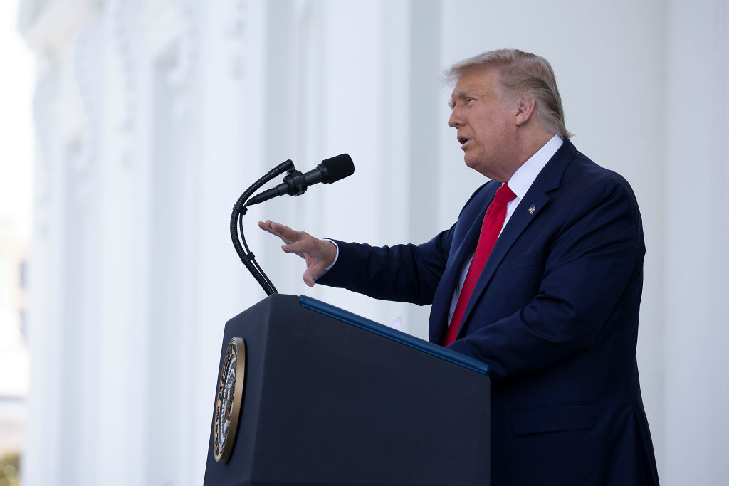 President Donald Trump delivers a speech outside at the While House podium