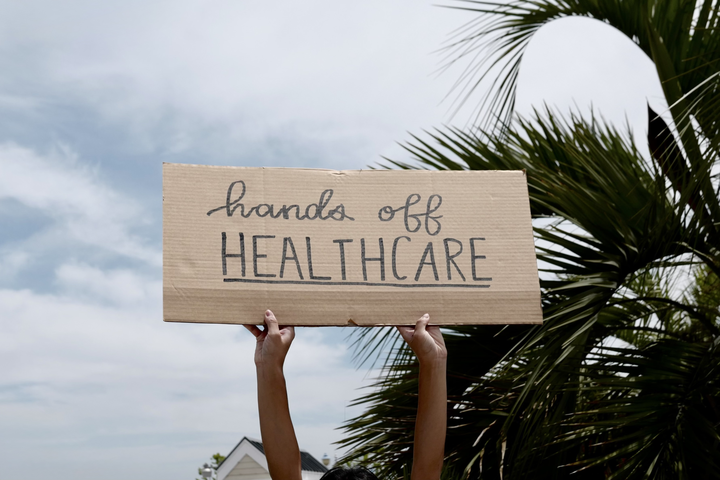 A sign with the words, "Hands off healthcare"