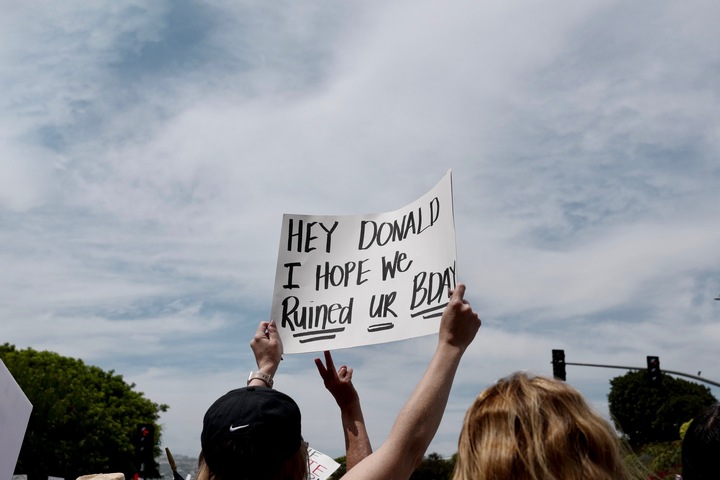 A sign with the words, "Hey Donald, I hope we ruined ur bday"