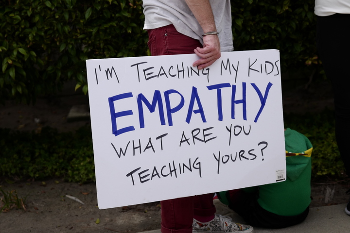 A sign with the words, "I'm teaching my kids empathy. What are you teaching yours?"