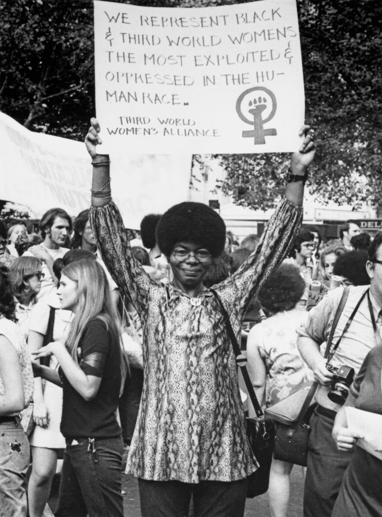 a sign which reads 'We represent Black and third world women, the most exploited and oppressed in the human race'