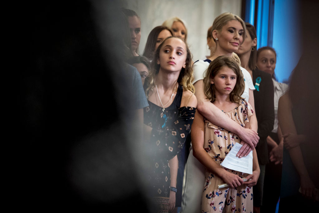 A group of women and girls stands together. 