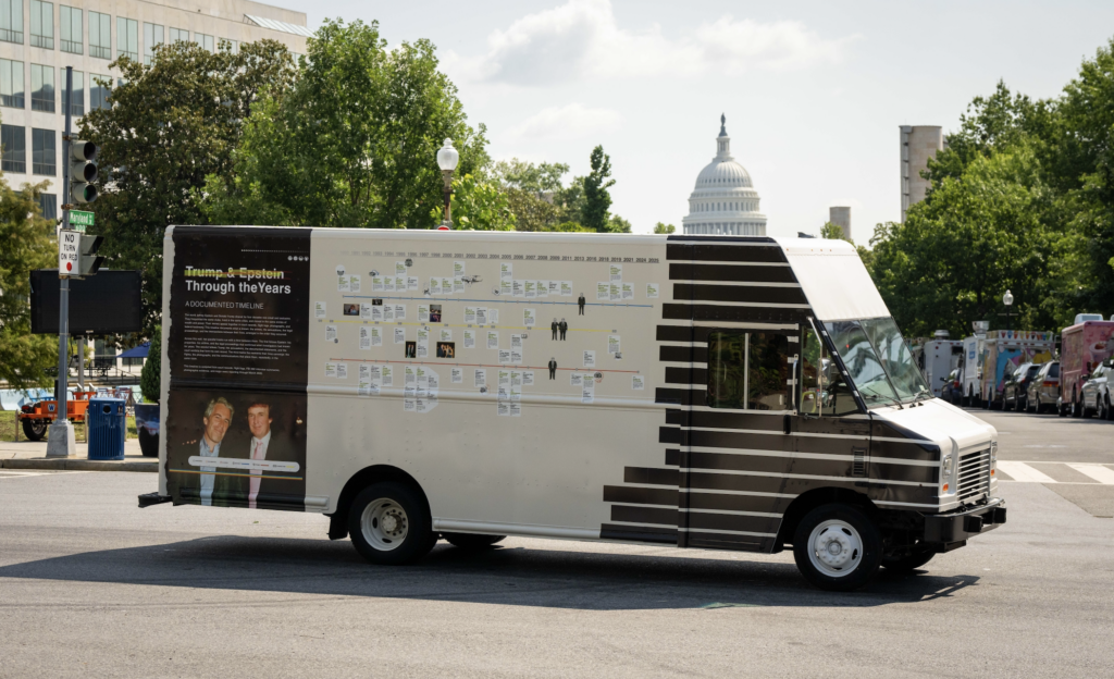 A van with information about the Epstein files painted on the side drives in front of the Capitol Building.