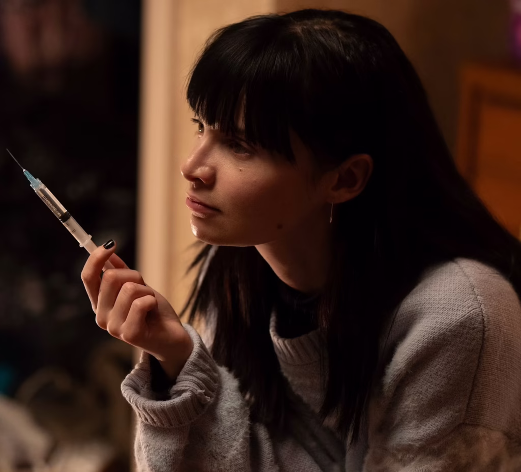 An actress in Furious holds a syringe. 